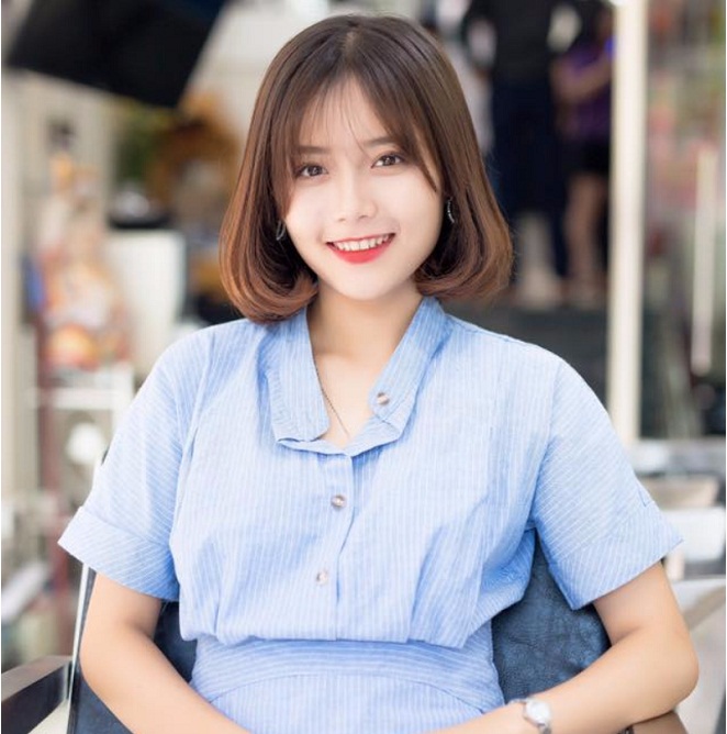 cô gái mặc áo xanh tóc ngang vai uốn cúp